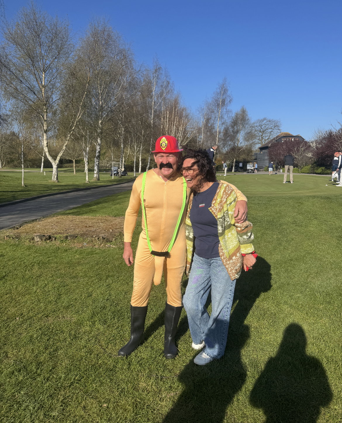 Gary Marshall at The Rayleigh Club in fancy dress on the fairway, sharing a laugh on a sunny day.